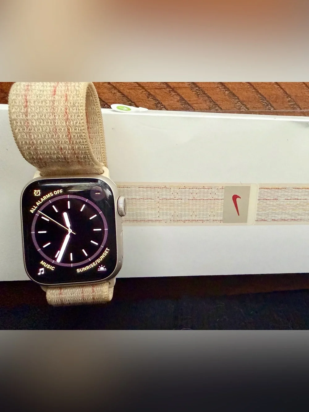 Series 8 41mm Apple Watch with Nike sport loop band and extra beige band.